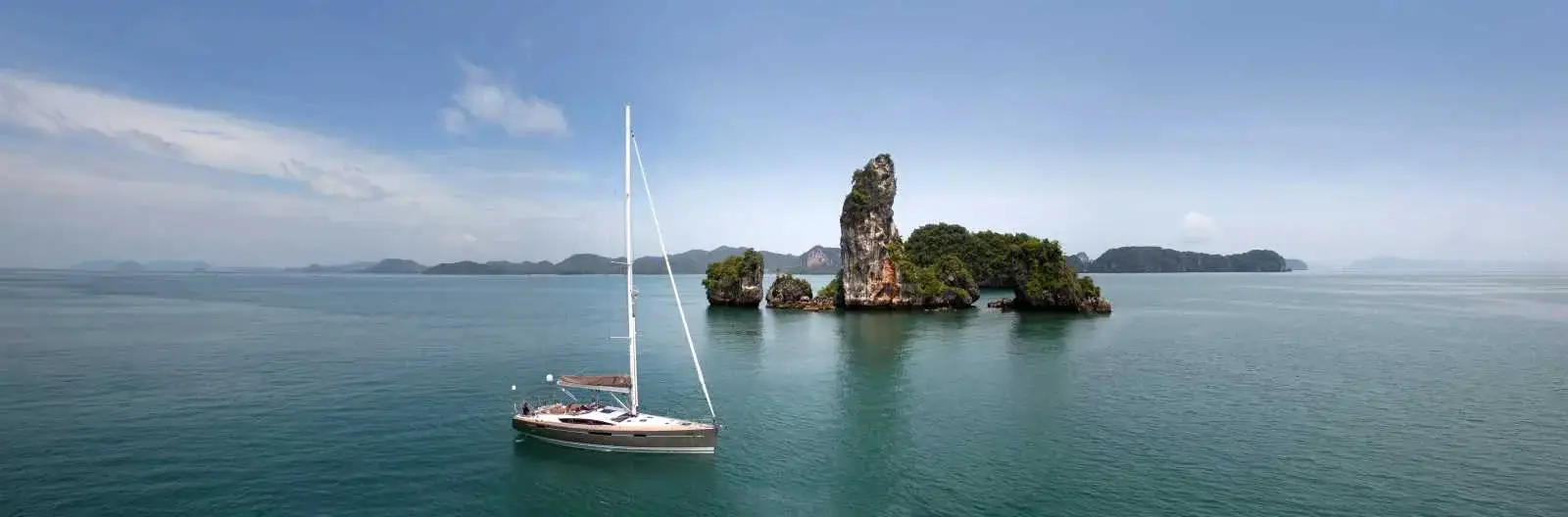 A Jeanneau sailing yacht at anchor off limestone islands